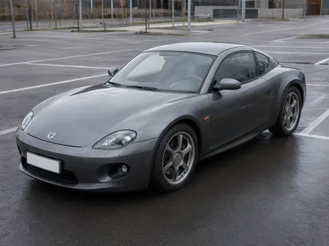 Front three-quarter photo of the car, plate covered